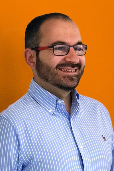 Man smiling on orange background
