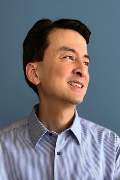 Man smiling on grey background