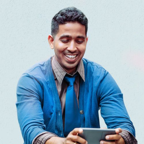 Man smiles at tablet