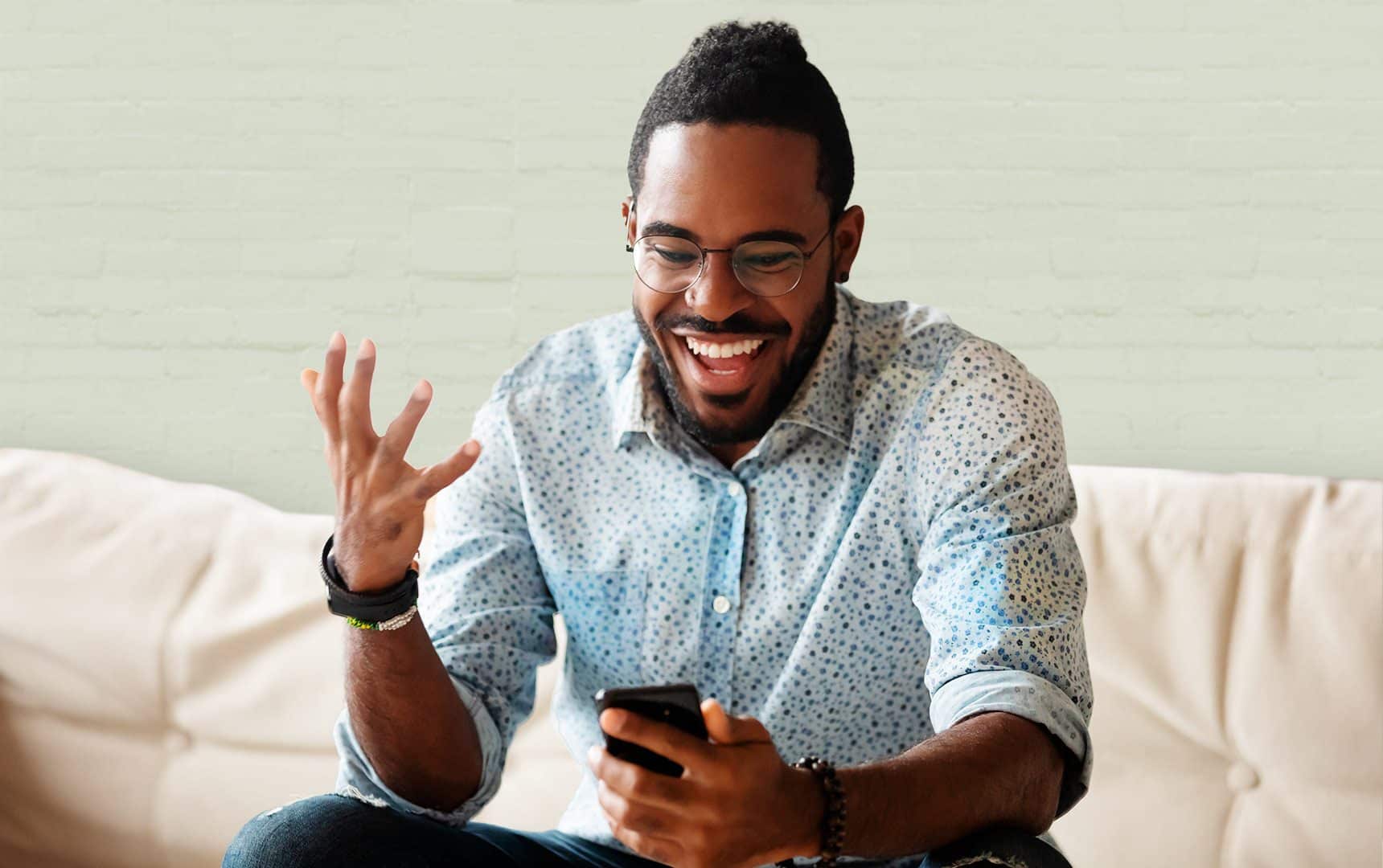 Man grinning at his smartphone