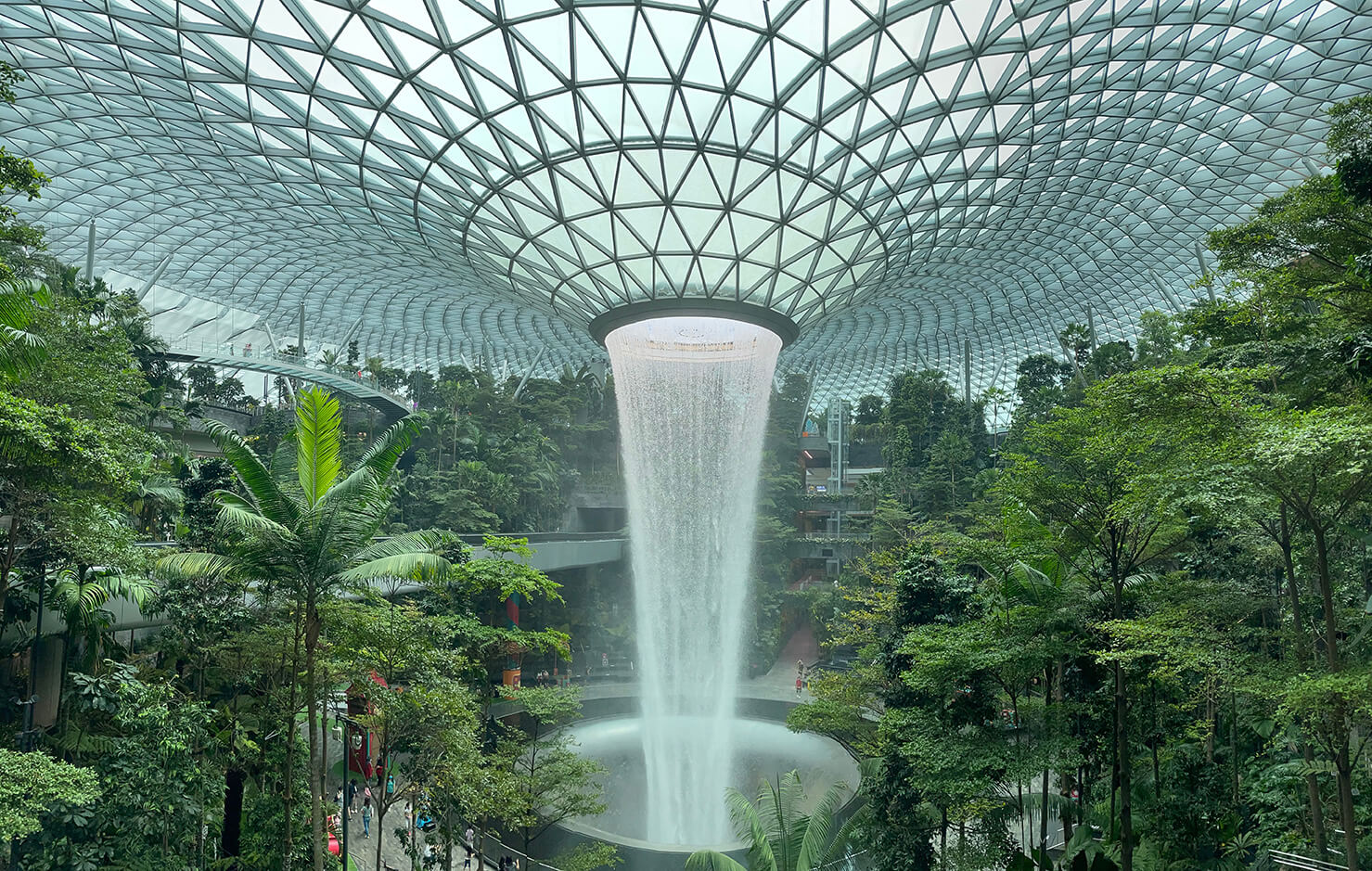 Futuristic green airport with artificial waterfall