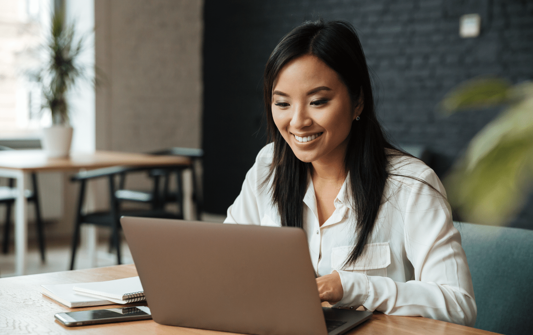 Woman working on the laptop and smiling