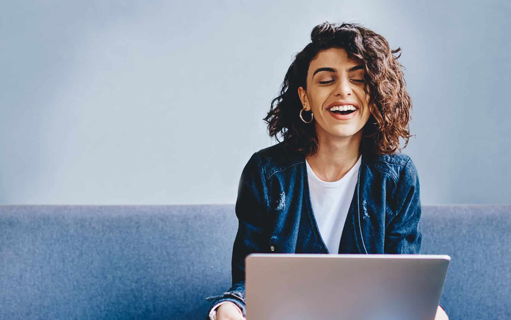 Woman smiling at laptop screen at Accelya Global