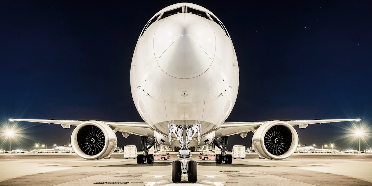 Accelya FLX Select: Front view of an illuminated airplane at night, highlighting advanced aviation technology and innovation