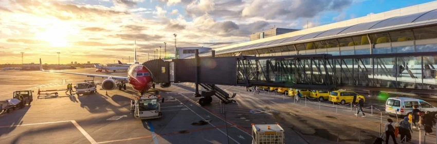 Airplane boarding at sunset, symbolizing Accelya's FLX ONE Delivery solution, which streamlines the passenger journey from booking to boarding with efficient, integrated airport operations.